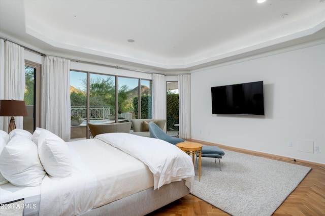 bedroom featuring a raised ceiling, access to outside, and parquet floors