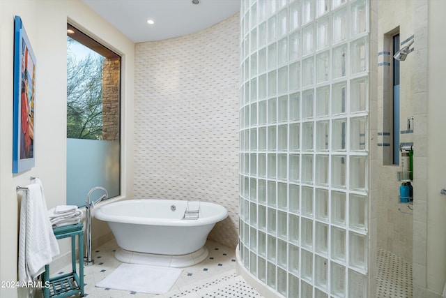 bathroom featuring tile floors and independent shower and bath