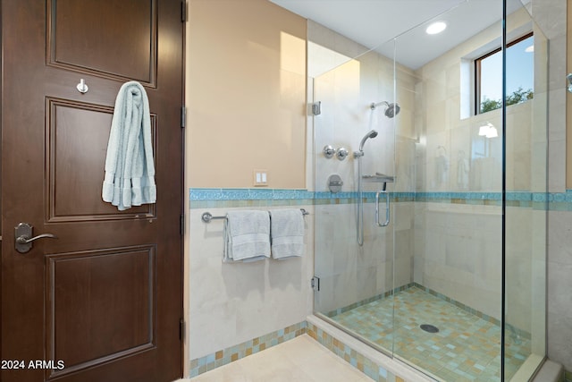 bathroom with tile floors and an enclosed shower