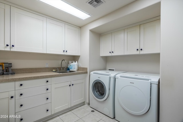 washroom with separate washer and dryer, cabinets, hookup for a washing machine, sink, and light tile floors