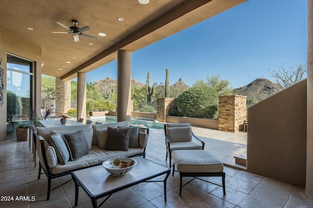 view of patio / terrace featuring ceiling fan, a mountain view, and an outdoor hangout area