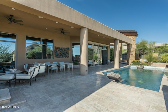 view of swimming pool featuring ceiling fan and a patio area