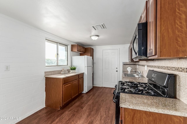 kitchen featuring sink, dark hardwood / wood-style floors, and black appliances