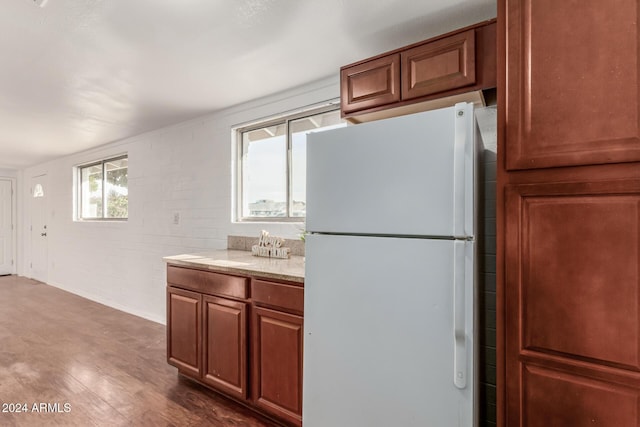 kitchen featuring dark hardwood / wood-style floors and white fridge