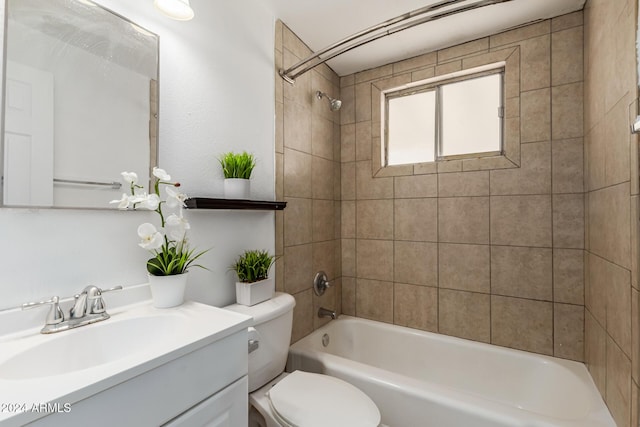 full bathroom featuring vanity, toilet, and tiled shower / bath combo