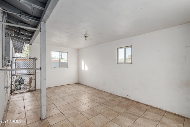 basement with a wealth of natural light and light tile patterned flooring