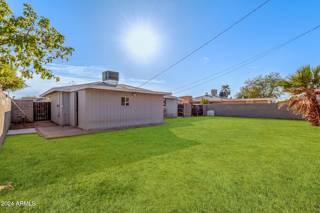 view of yard with an outdoor structure and central air condition unit