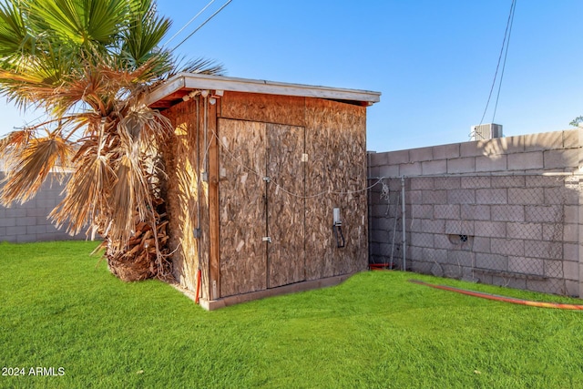 view of outbuilding featuring a lawn