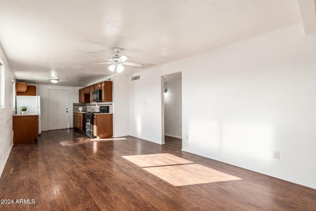 unfurnished living room with ceiling fan and dark hardwood / wood-style flooring