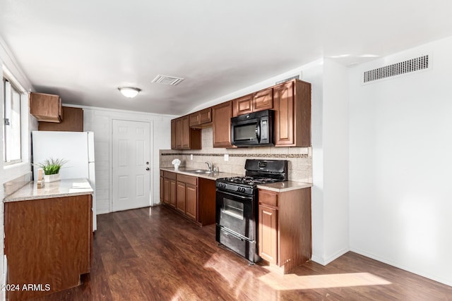 kitchen featuring decorative backsplash, dark hardwood / wood-style flooring, sink, and black appliances