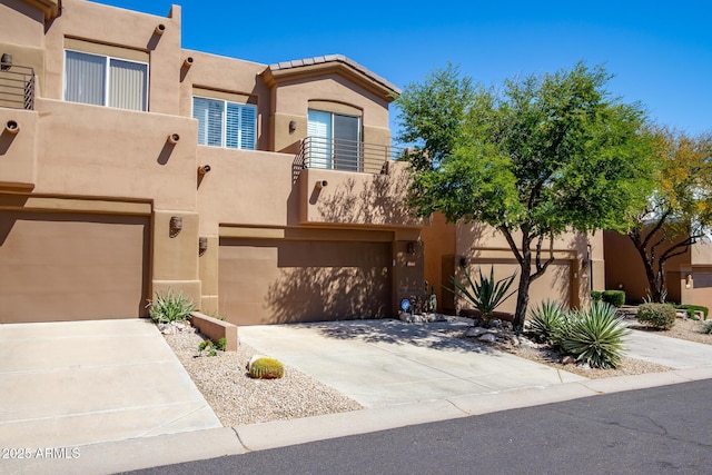 southwest-style home with a balcony and a garage