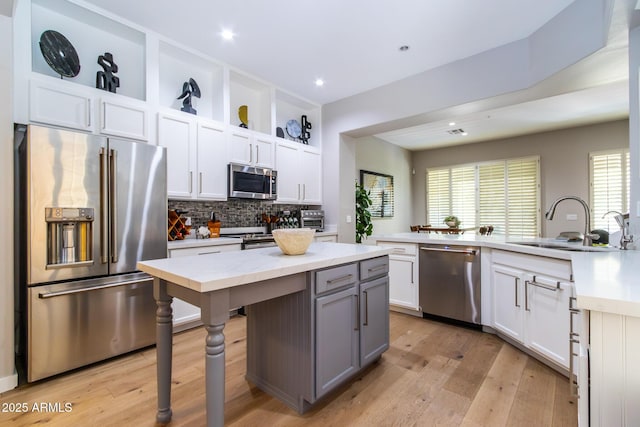 kitchen featuring white cabinets, appliances with stainless steel finishes, and a kitchen island