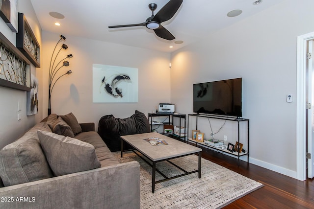 living room featuring ceiling fan and dark hardwood / wood-style floors