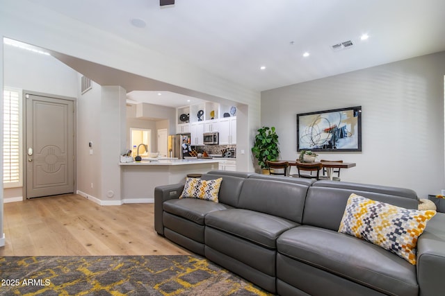 living room with light hardwood / wood-style flooring