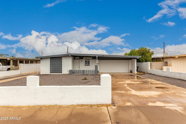 3828 W Townley Ave, Phoenix, AZ 85051 - view of front of home featuring fence, a garage, concrete driveway, and concrete block siding
