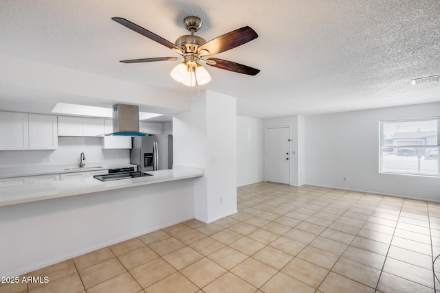 5504 N 69th Ave, Glendale, AZ 85303 - kitchen featuring stainless steel fridge with ice dispenser, light countertops, island range hood, a sink, and white cabinetry