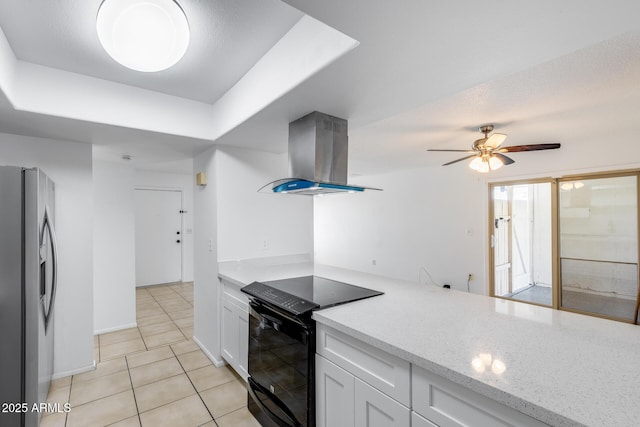 5504 N 69th Ave, Glendale, AZ 85303 - kitchen featuring island range hood, stainless steel fridge with ice dispenser, black range with electric stovetop, light tile patterned flooring, and white cabinetry