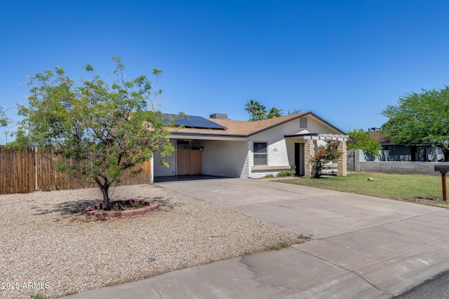 5504 N 69th Ave, Glendale, AZ 85303 - single story home with concrete driveway, solar panels, and a carport