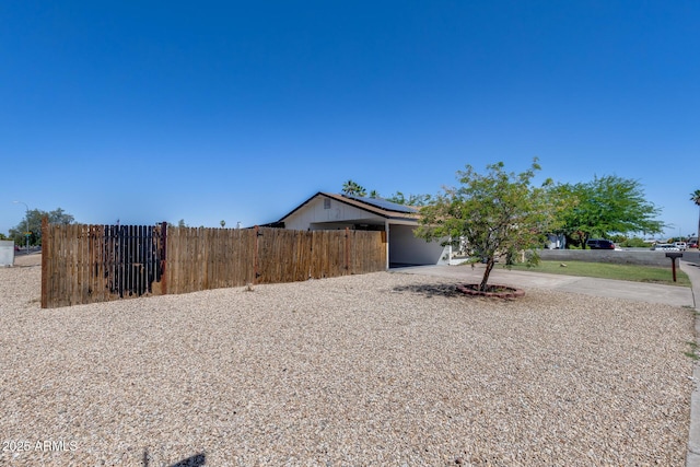 5504 N 69th Ave, Glendale, AZ 85303 - view of side of property with solar panels, concrete driveway, and a carport