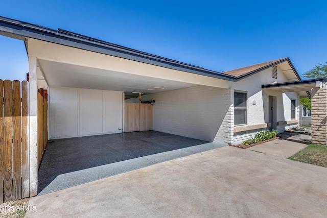 5504 N 69th Ave, Glendale, AZ 85303 - view of front of property with a carport, driveway, and brick siding