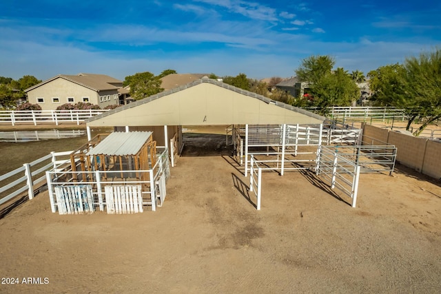 view of stable with a rural view