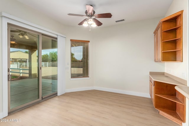 unfurnished dining area with ceiling fan and light hardwood / wood-style flooring