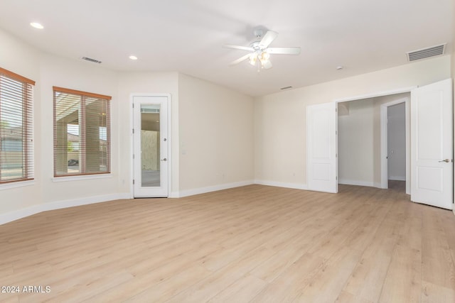 empty room featuring light wood-type flooring and ceiling fan