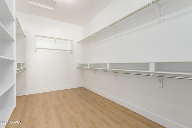 spacious closet with hardwood / wood-style floors