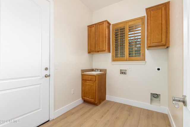 washroom featuring sink, cabinets, electric dryer hookup, hookup for a washing machine, and light wood-type flooring