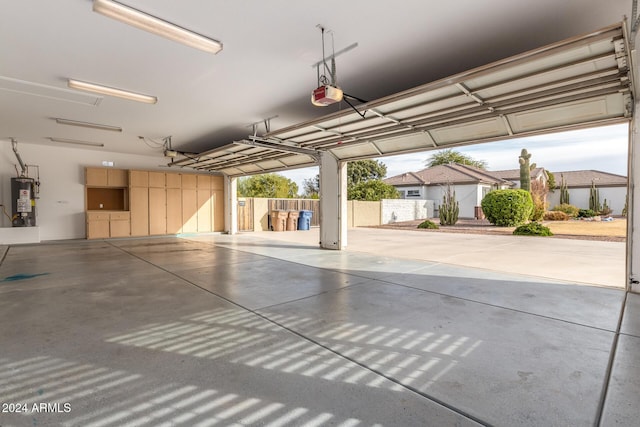 garage featuring water heater and a garage door opener