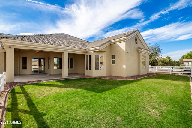 back of house featuring a patio area and a yard