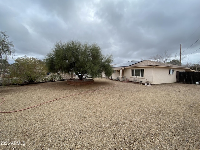 exterior space featuring solar panels and stucco siding