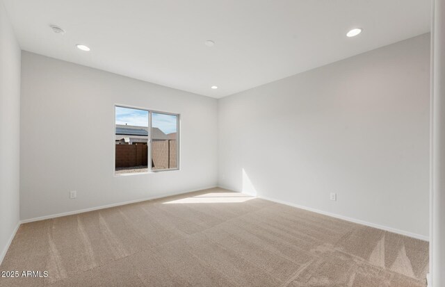 carpeted empty room with baseboards and recessed lighting