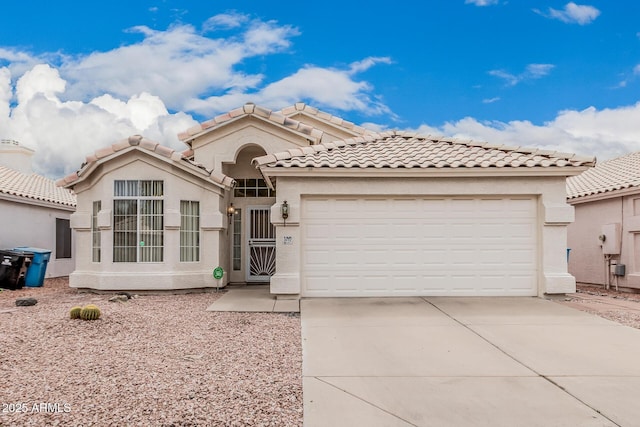 3349 E Lavey Ln, Phoenix, AZ 85032 - mediterranean / spanish house featuring driveway, stucco siding, an attached garage, and a tile roof