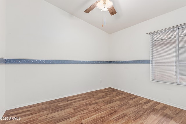 3349 E Lavey Ln, Phoenix, AZ 85032 - unfurnished room with wood finished floors, ceiling fan, baseboards, and vaulted ceiling