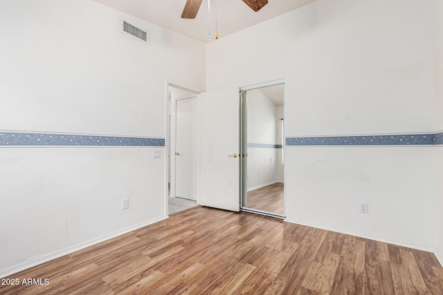 3349 E Lavey Ln, Phoenix, AZ 85032 - unfurnished bedroom featuring visible vents, baseboards, ceiling fan, and wood finished floors