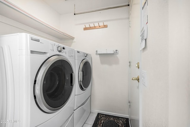 3349 E Lavey Ln, Phoenix, AZ 85032 - clothes washing area with light tile patterned floors, washing machine and dryer, laundry area, and baseboards