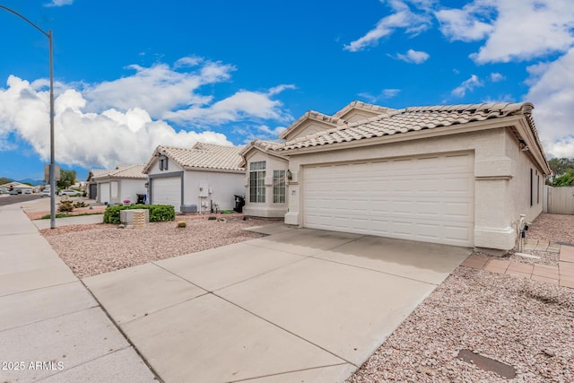 3349 E Lavey Ln, Phoenix, AZ 85032 - mediterranean / spanish-style home with concrete driveway, a tile roof, a garage, and stucco siding