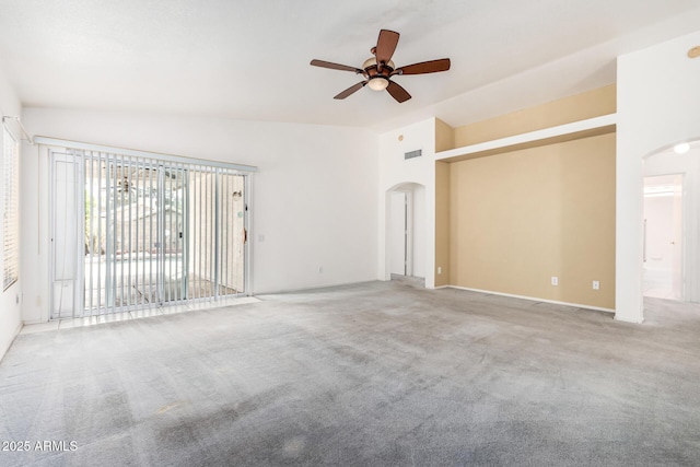 3349 E Lavey Ln, Phoenix, AZ 85032 - unfurnished living room featuring arched walkways, vaulted ceiling, a ceiling fan, and carpet floors