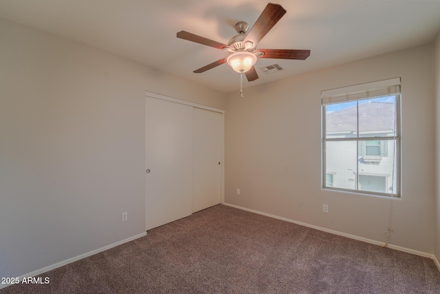 unfurnished bedroom featuring carpet flooring, ceiling fan, and a closet