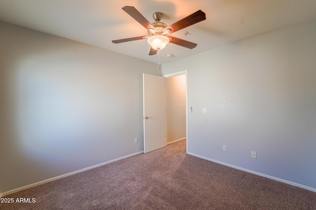 spare room featuring ceiling fan and carpet flooring