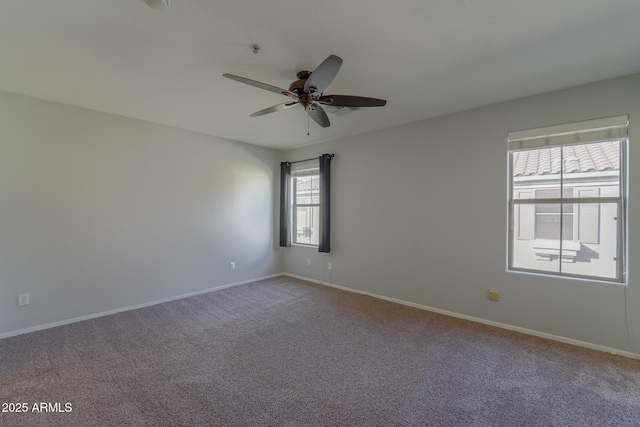 carpeted spare room featuring ceiling fan