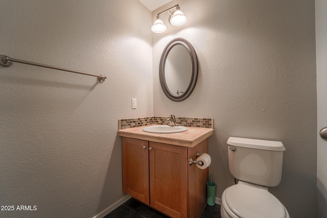 bathroom with vanity, toilet, and tile patterned flooring