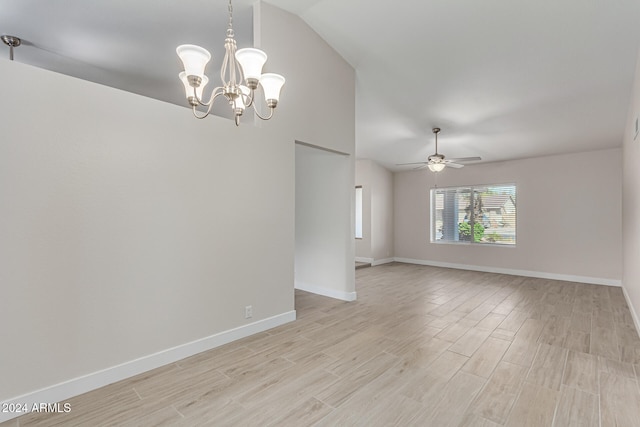 unfurnished room with ceiling fan with notable chandelier, vaulted ceiling, and light hardwood / wood-style flooring