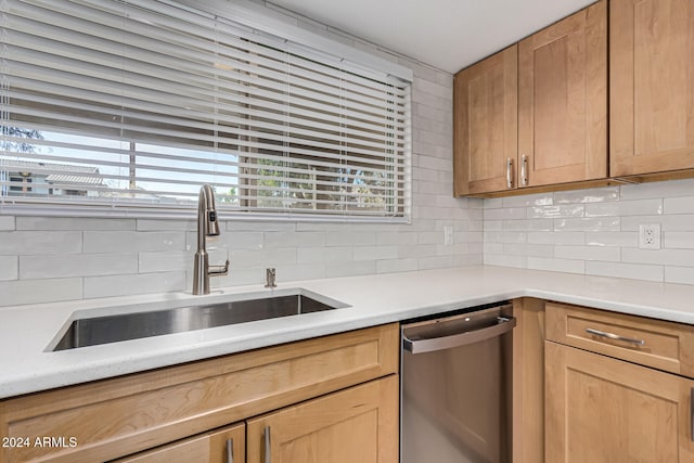 kitchen with dishwasher, backsplash, and sink