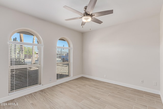 unfurnished room with ceiling fan and light hardwood / wood-style flooring