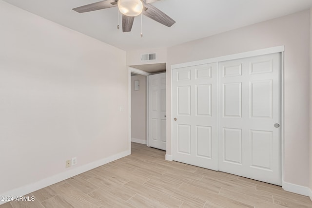 unfurnished bedroom featuring a closet, ceiling fan, and light hardwood / wood-style flooring