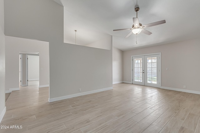 unfurnished room with high vaulted ceiling, ceiling fan, french doors, and light hardwood / wood-style floors