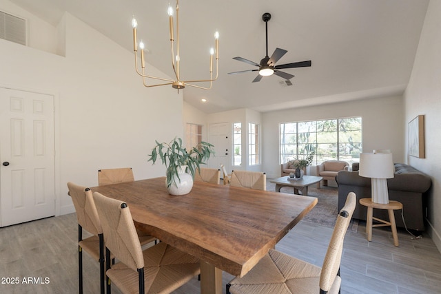 4037 E Milton Dr, Cave Creek, AZ 85331 - dining area featuring light wood finished floors, ceiling fan, high vaulted ceiling, and a chandelier