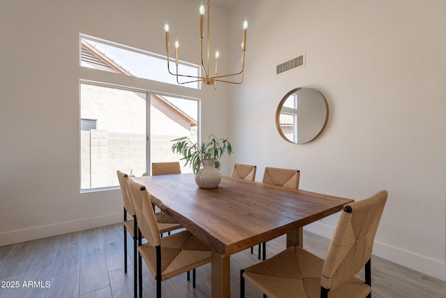 4037 E Milton Dr, Cave Creek, AZ 85331 - dining space featuring a chandelier, light wood-type flooring, and a towering ceiling